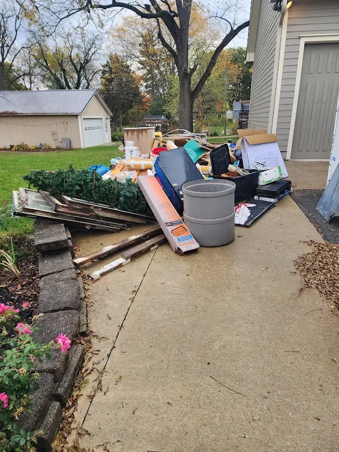 Dumpster being loaded with debris for 3 Yard Dumpster Rental in Kirkwood